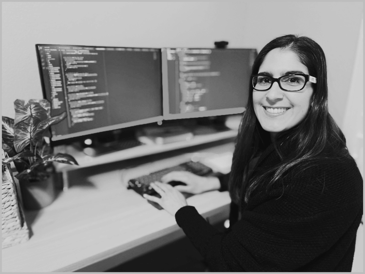 Shirene at her desk black and white